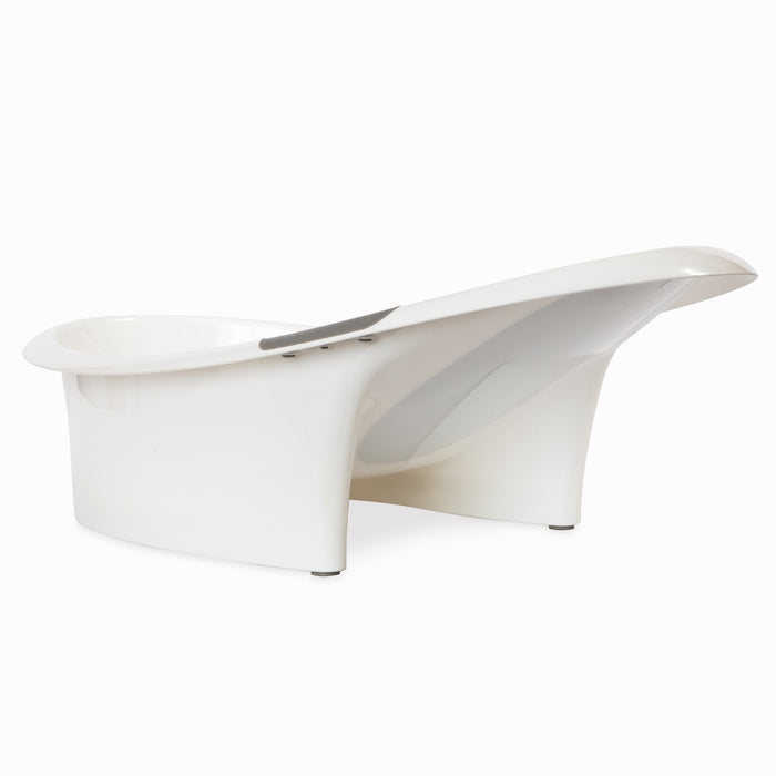 The Nuby Comfort Baby Bathtub is a modern, white tub with a contoured shape, high backrest, and sturdy base. Its elevated back and smooth glossy finish provide added comfort and support for newborns.