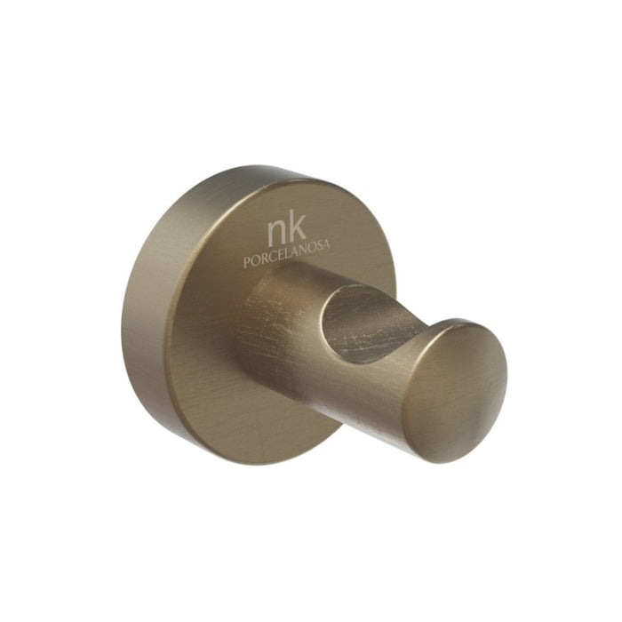 Brass-colored wall hook with 'nk' branding on a white background