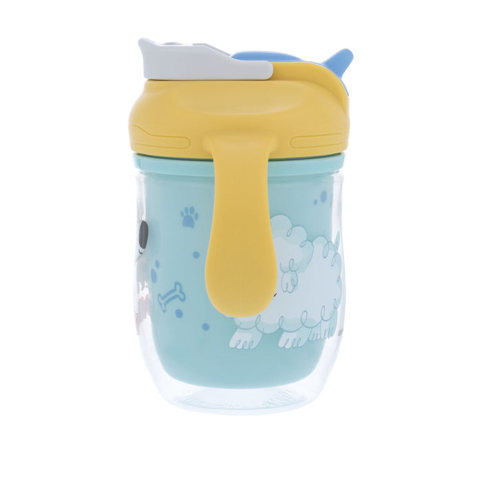 The Nuby 2-in-1 Insulated Toddler Cup | Dogs is a clear plastic sippy cup with a yellow lid and easy-grip handles, featuring cute dog designs and paw prints on a light blue background.