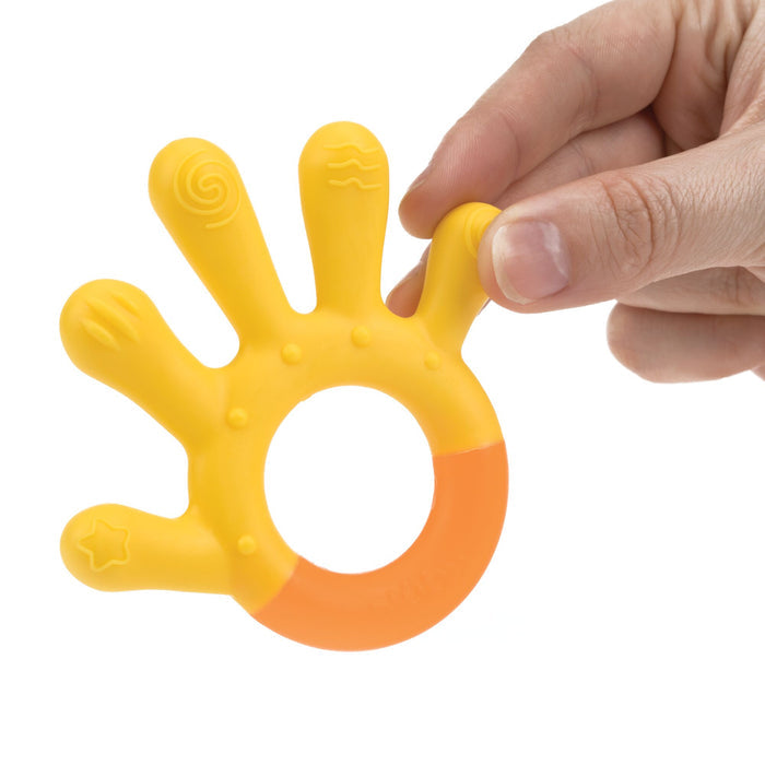 A hand holding the 3 Step Baby Teether, a yellow and orange silicone teether shaped like a hand, with different textured symbols on each finger.