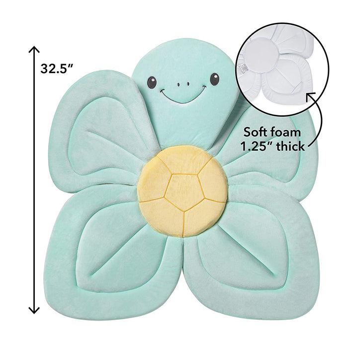 The Baby Bath Sink & Tub Cushion is a plush, light blue flower-shaped mat with a smiling face and yellow center. Measuring 32.5" across and 1.25" thick, it’s perfect for bathing babies in sinks or tubs. Inset highlights the soft foam detail.