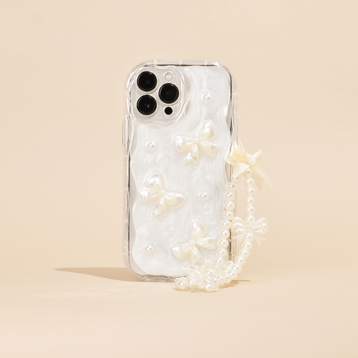 Clear phone case with white bow accents and beaded phone strap, displayed on a beige background.