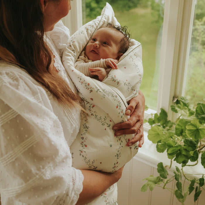 Botanical Berries Baby Duve wrapped around baby in mothers arms