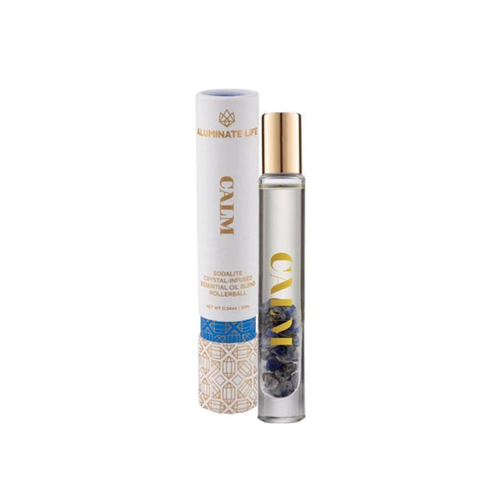 Calm RollerBall | Aluminate Life with clear glass rollerball bottle containing blue sodalite crystals and matching white and gold cylindrical packaging for wellness and skincare.