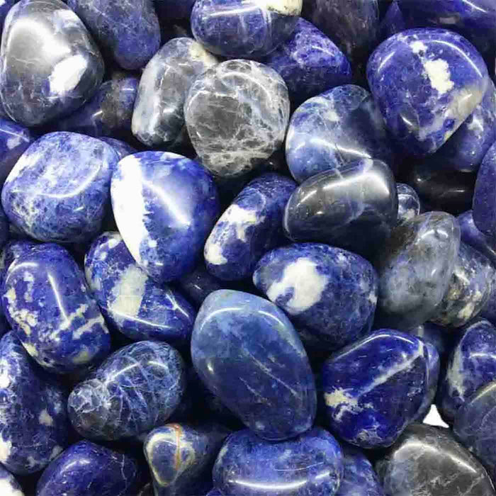 Close-up of polished blue and white stones with natural veining, evoking a calming and soothing aesthetic for the Calm RollerBall | Aluminate Life wellness experience.