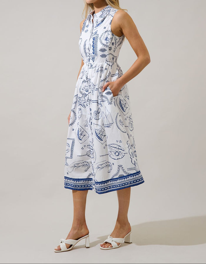 Side view of white and navy seaside print sleeveless midi shirtdress with pockets