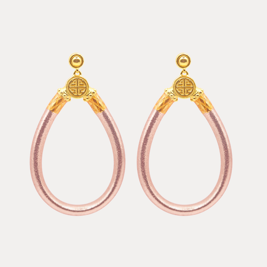 a pair of earrings with gold accents