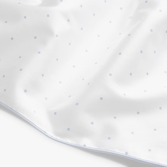 Close-up of a white fabric with small blue dots