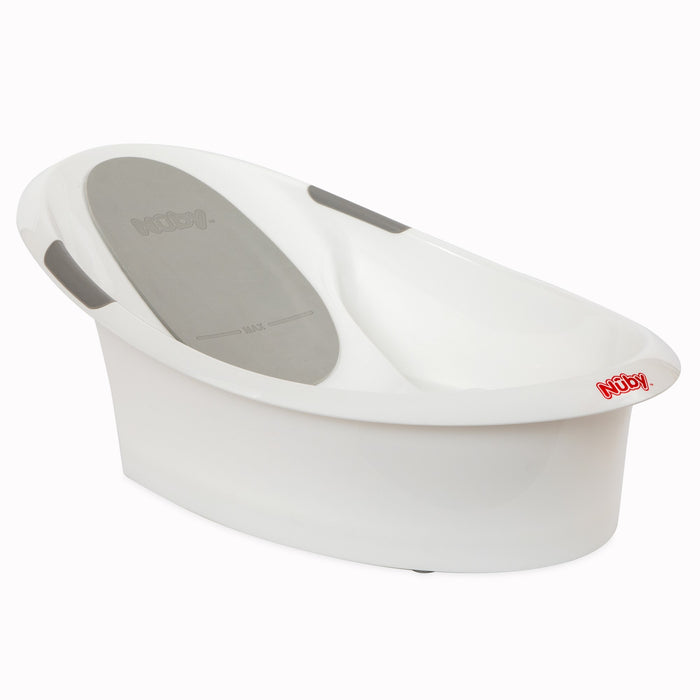 The Nuby Comfort Baby Bathtub is a white plastic tub with a built-in gray backrest, side handles, and the Nuby logo in red on the front edge, designed to provide comfortable support for newborns during bath time.