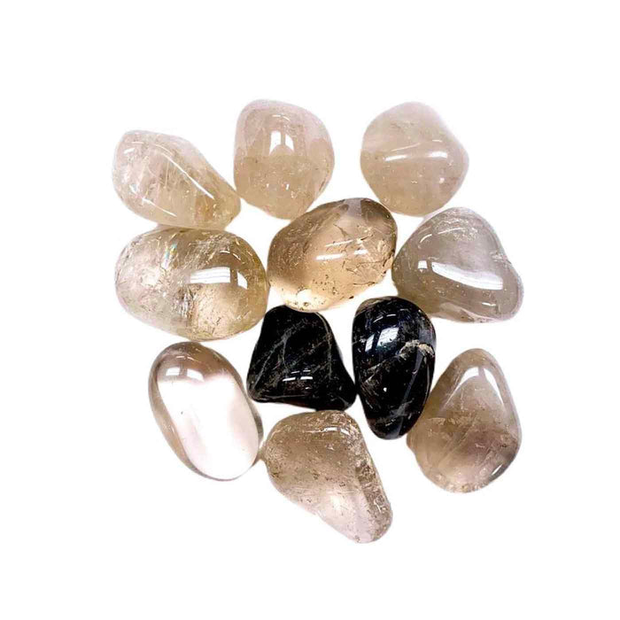 Polished smoky quartz and black tourmaline stones arranged in a circle, highlighting natural wellness elements related to the Defense Candle Tin | Aluminate Life.