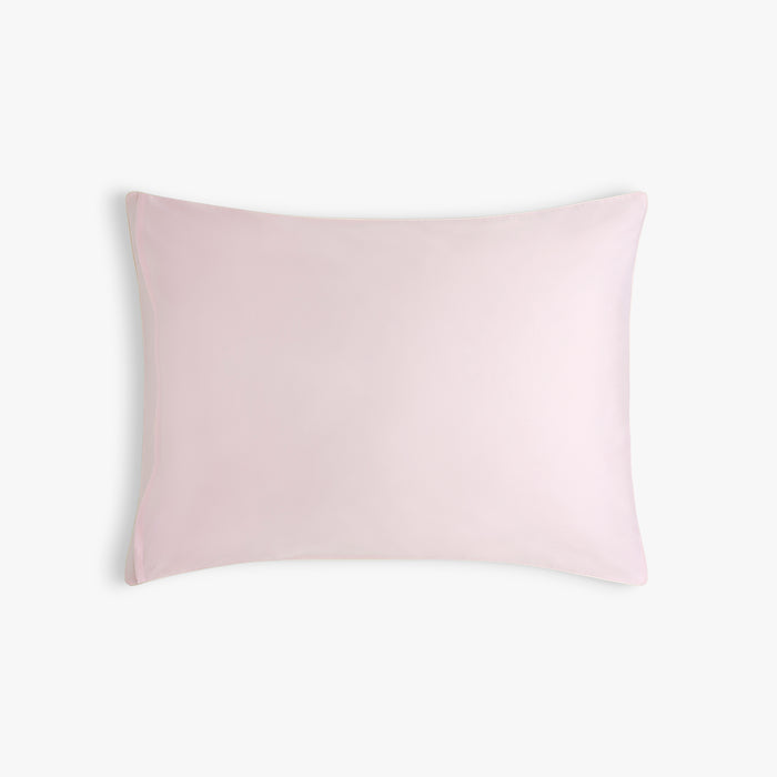 Light pink pillow on a white background