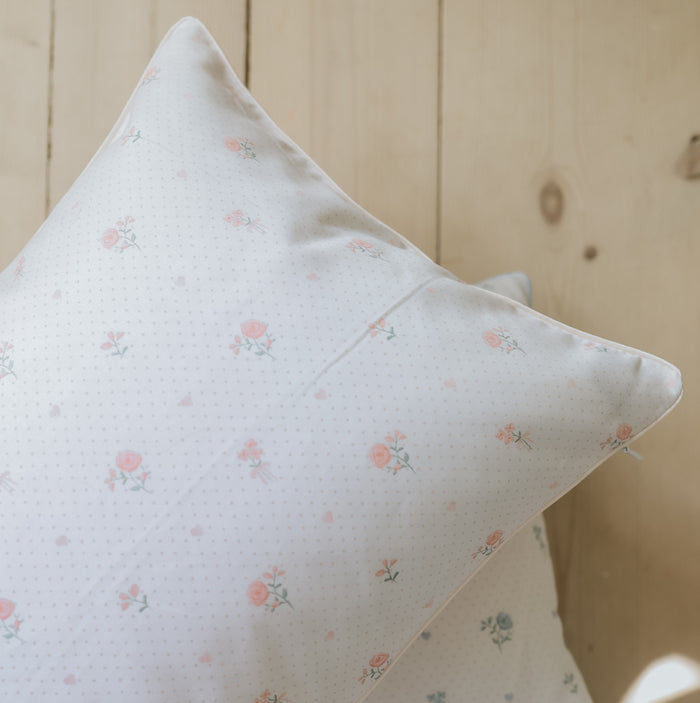 Close up on standard pillow in ditsy pink floral.