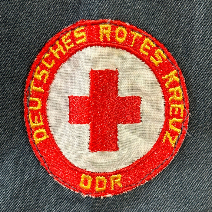 Patch of the German Red Cross on a dark fabric background