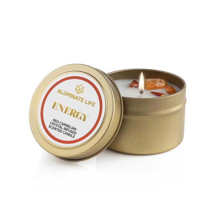 Energy Candle Tin | Aluminate Life with red carnelian crystals infused in a scented candle, featuring a gold metal tin and a warm flickering flame for wellness and energy.