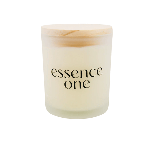 Minimalist frosted glass candle jar with a wooden lid, featuring the text "essence one," representing the Essential Oil Soy Candle | Essence One for a calming wellness experience.