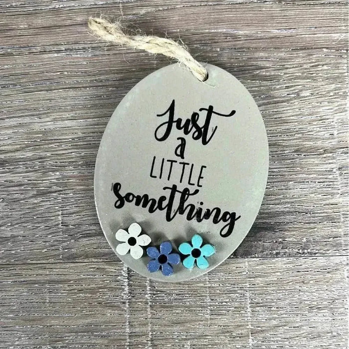 Wooden gift tag with "Just A Little Something" text