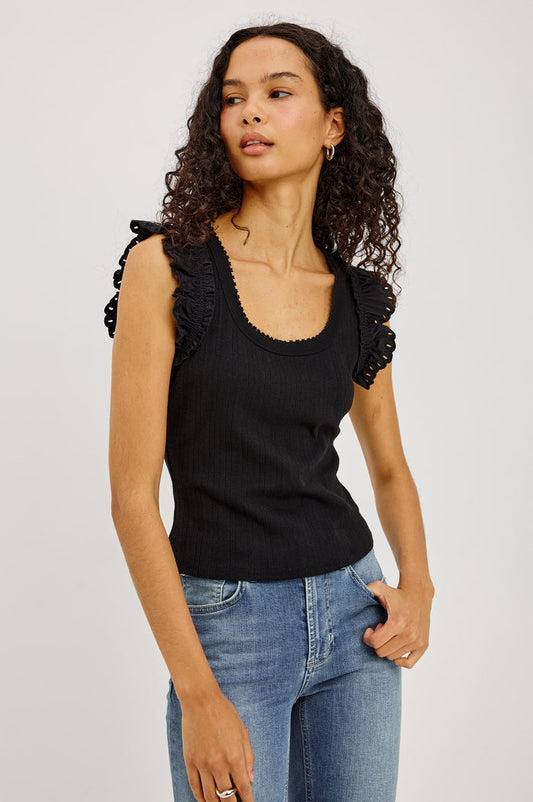 Giovanna Top in Soft Pointelle Cotton With Scoop Neck, Scalloped Trim, Ruffled Flutter Sleeves in Black Colorway - Upper Body Front View Featured on Model