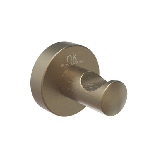 Brass-colored wall hook with 'nk' branding on a white background