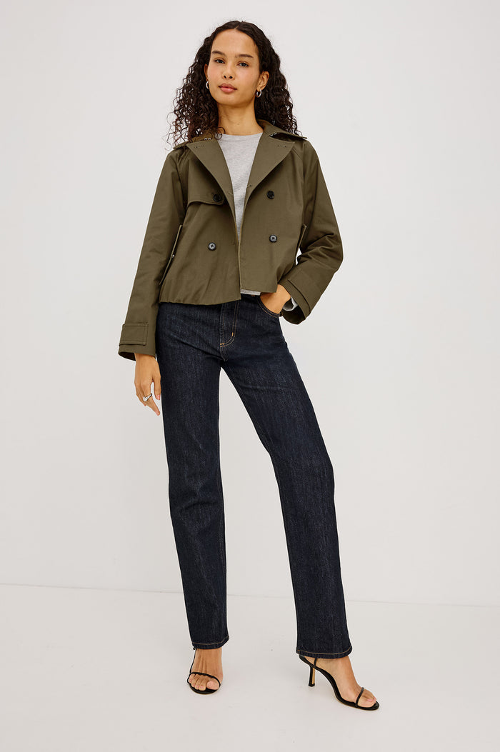 Jett Cropped Trench Jacket in Cotton Garbardine With Double-Breasted Design, Structured Collar, Pockets, and Long Cuffed Sleeves in Olive Colorway - Full Body Front View Featured on Model