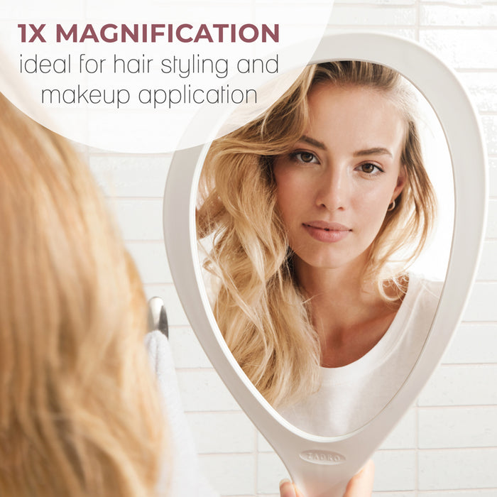 Zadro ZHSL1WHT 705004424844 environment photo front view user in reflection with features, new large teardrop handheld mirror with hanging handle in front of a real life setting