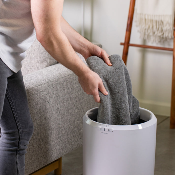 Zadro TWB01 705004422918 environment photo close up user removing towels, large towel warmer bucket in front of a real life setting