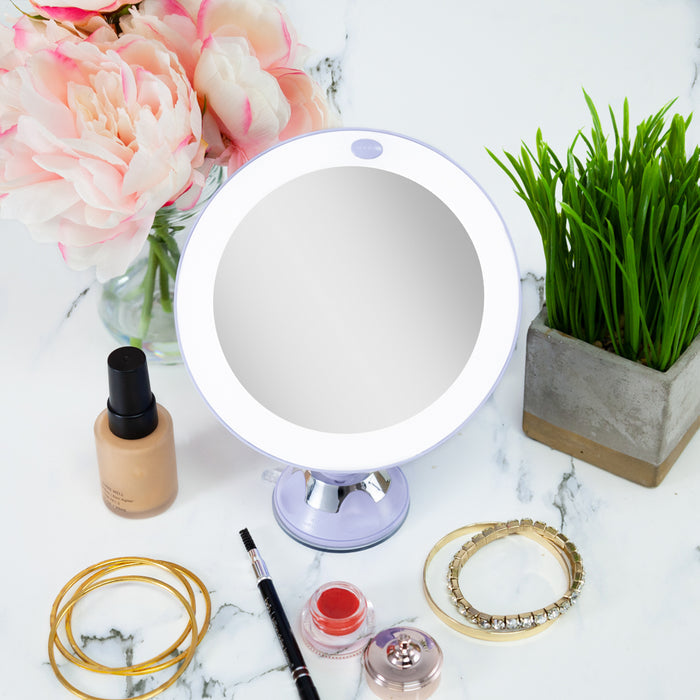 Zadro LEDPSC2003 705004422062 environment photo overhead view on makeup table with jewelry, lighted wall mounted makeup mirror with magnification & suction cup in front of a real life setting