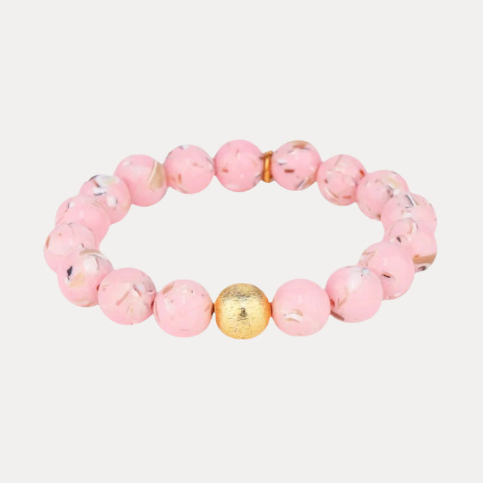 a pink beaded bracelet with a gold bead