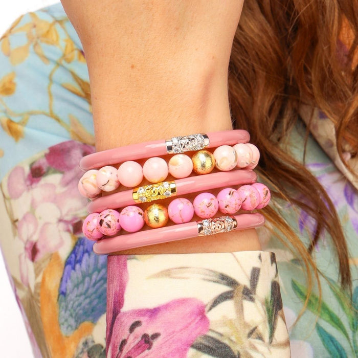 a woman wearing bracelets on her arm