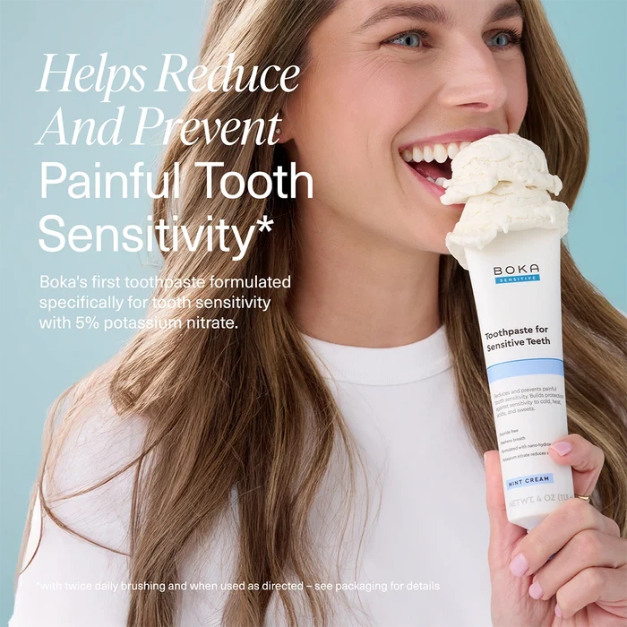 Woman holding a tube of Boka toothpaste with text about tooth sensitivity relief.