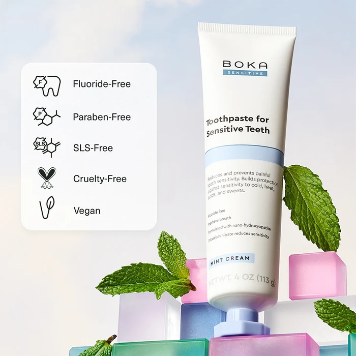 Boka toothpaste for sensitive teeth with mint leaves on a light background