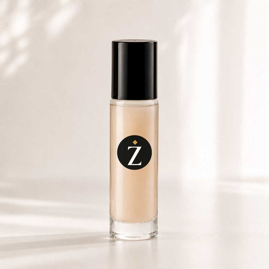 A clear cylindrical bottle of liquid foundation with a black cap, filled with beige makeup, standing on a white surface against a softly lit white background with subtle shadow patterns.