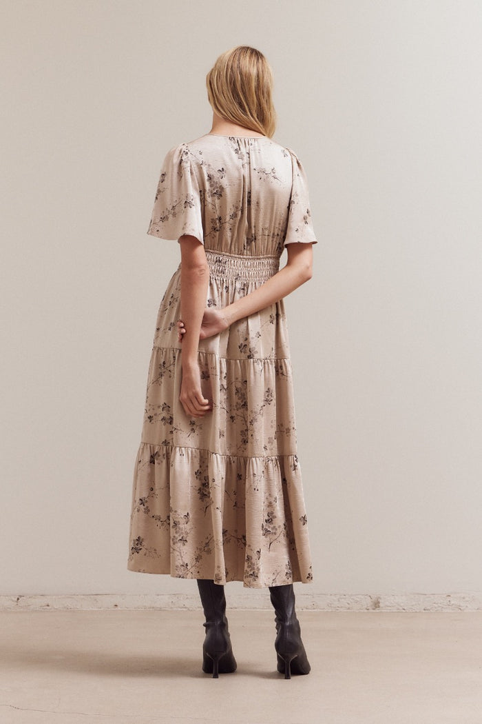Back view of natural floral print midi dress with flutter sleeves
