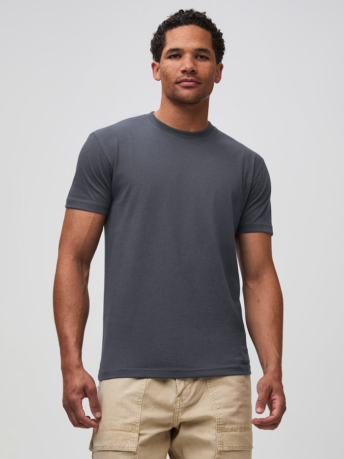 Mikah is 6'1" and wears a size medium in FCT # Nightfall deep navy crew neck t-shirt for men, StratuSoft™ fabric