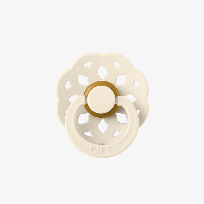 White and rubber pacifier on a white background