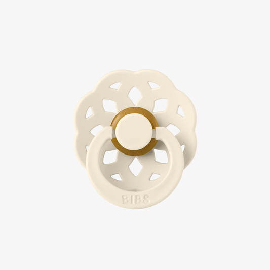 White and rubber pacifier on a white background