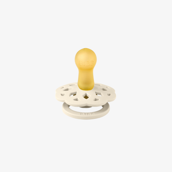 White pacifier with a natural rubber nib on a white background