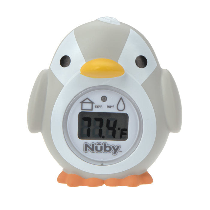 The Nuby Penguin Bath & Room Thermometer, shaped like a gray and white penguin with orange beak and feet, displays 77.4°F on its screen—making it a cute and practical temperature monitor for your little one.