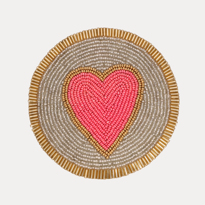 a heart shaped beaded mat