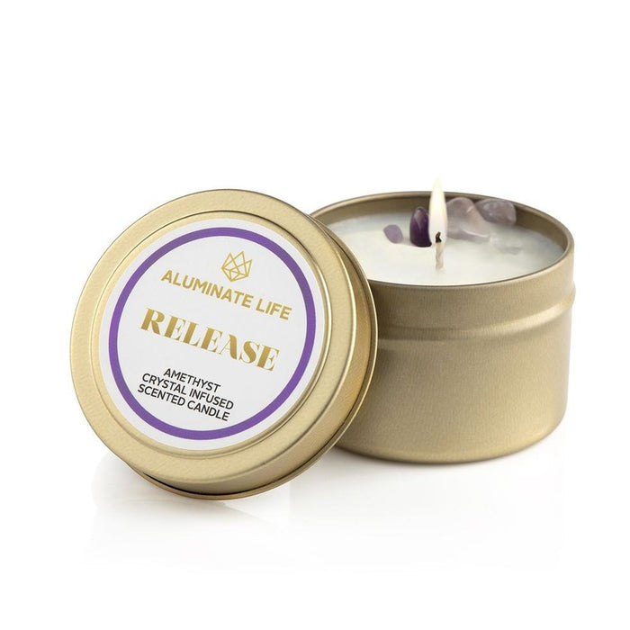 Release Candle Tin | Aluminate Life featuring a gold-colored tin with a scented candle infused with amethyst crystals, lit and ready for relaxation and wellness ambiance.