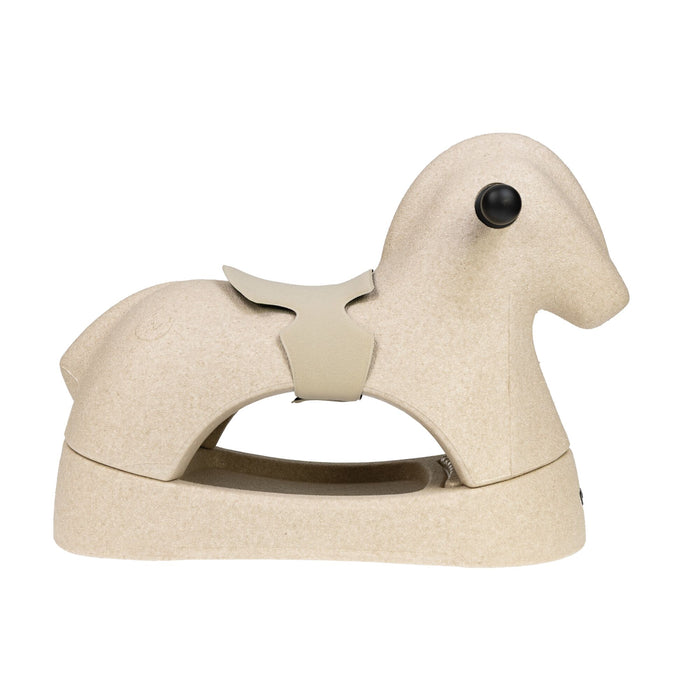 The Rock 'N Ride | Beige is a minimalist EPP foam rocker shaped like a rocking horse, featuring a simple saddle and round black eyes, shown in side profile on a white background.