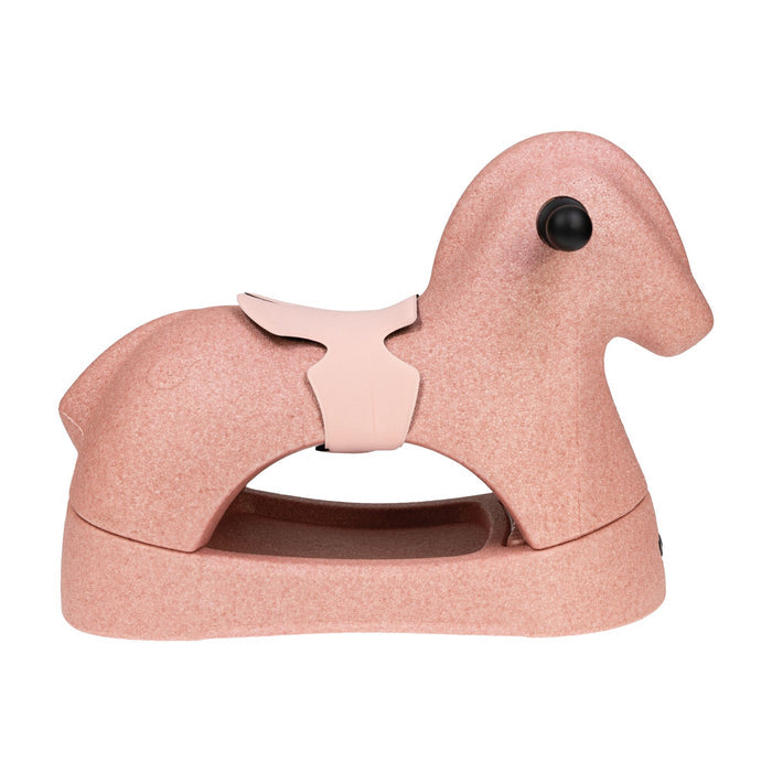 The Rock 'N Ride | Pink is a minimalist 3-in-1 ride-on toy for young children, featuring a smooth EPP foam surface, black eyes, and a small saddle.