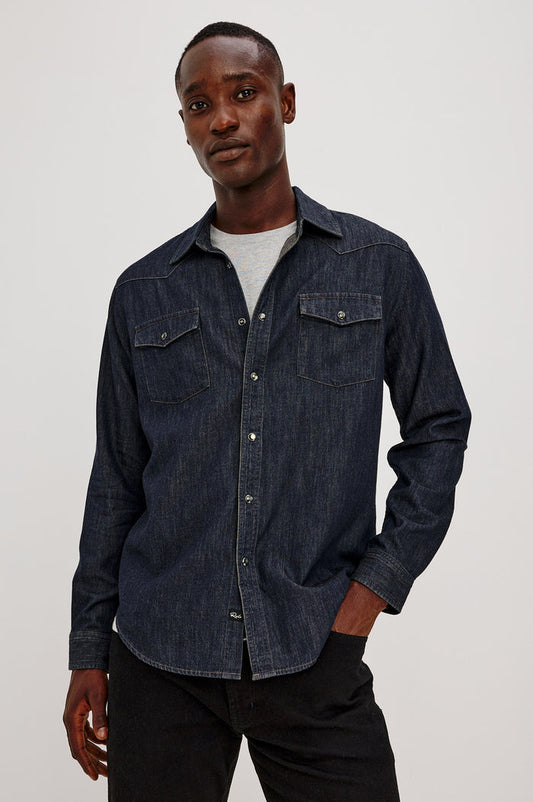 Roy Shirt in Rigid Rinsed Denim With Western Shoulder and Back Yokes, Spread Collar, Snap Front, Dual Chest Flap Pockets, and Shirttail Hem in Twilight Wash Colorway - Upper Body Front View Featured on Model