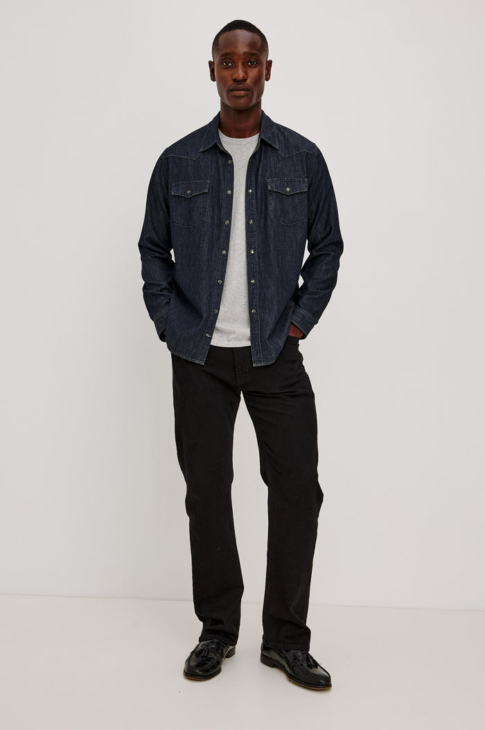 Roy Shirt in Rigid Rinsed Denim With Western Shoulder and Back Yokes, Spread Collar, Snap Front, Dual Chest Flap Pockets, and Shirttail Hem in Twilight Wash Colorway - Full Body Front View Featured on Model