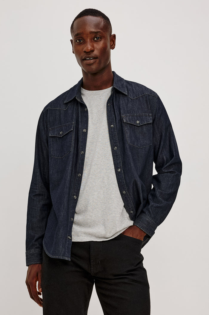 Roy Shirt in Rigid Rinsed Denim With Western Shoulder and Back Yokes, Spread Collar, Snap Front, Dual Chest Flap Pockets, and Shirttail Hem in Twilight Wash Colorway - Upper Body Front View Featured on Model