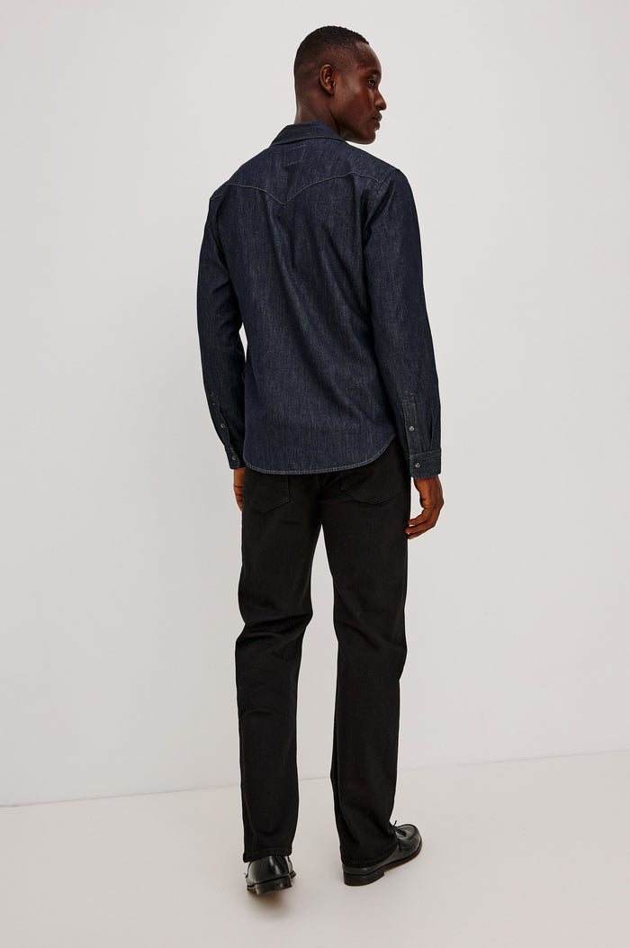 Roy Shirt in Rigid Rinsed Denim With Western Shoulder and Back Yokes, Spread Collar, Snap Front, Dual Chest Flap Pockets, and Shirttail Hem in Twilight Wash Colorway - Full Body Back View Featured on Model