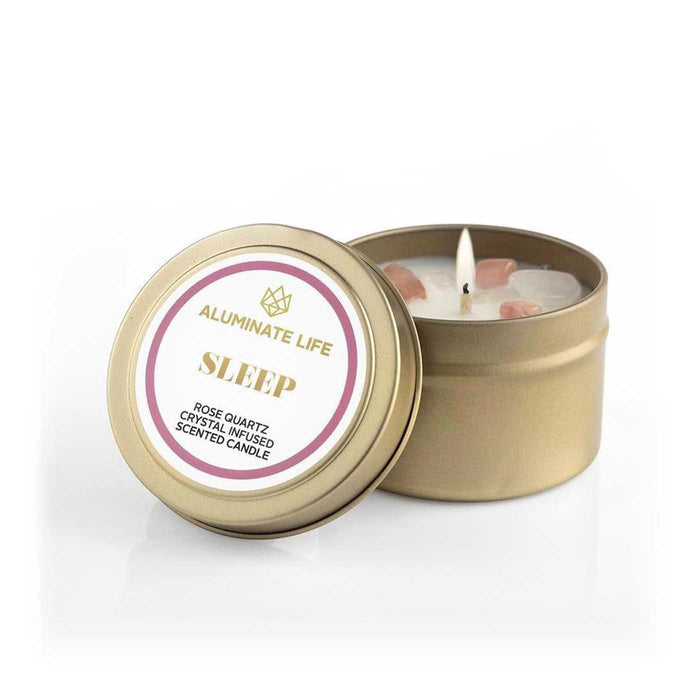 Sleep Candle Tin | Aluminate Life with rose quartz crystals, scented to promote relaxation and wellness, displayed with a lit wick in a gold metal container.