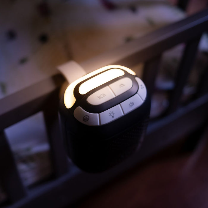The Nuby Stroller Rocker, softly lit and equipped with easy-to-use buttons, attaches to a stroller and plays calming sounds to comfort your baby in low-light settings.