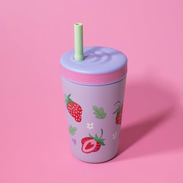 The Nuby Thirsty Kids Flexstraw Stainless Steel Cup | Strawberries, in lavender with a green no-spill straw and strawberry design, sits on a pink surface—a perfect kids’ cold drink cup.