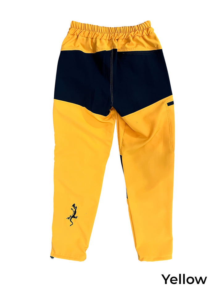 TURK MOUNTAIN men's yellow and black climbing pants with elastic waistband, reinforced knees, and lizard graphic.