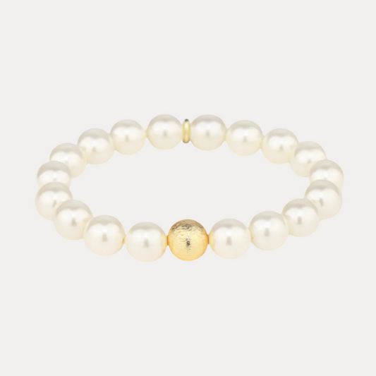 a white pearl bracelet with a gold bead
